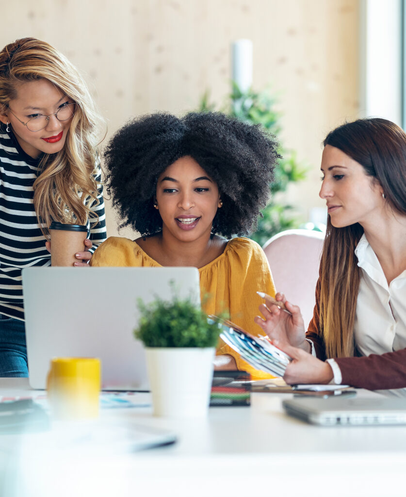 Casual multiethnic business women working with laptops while tal